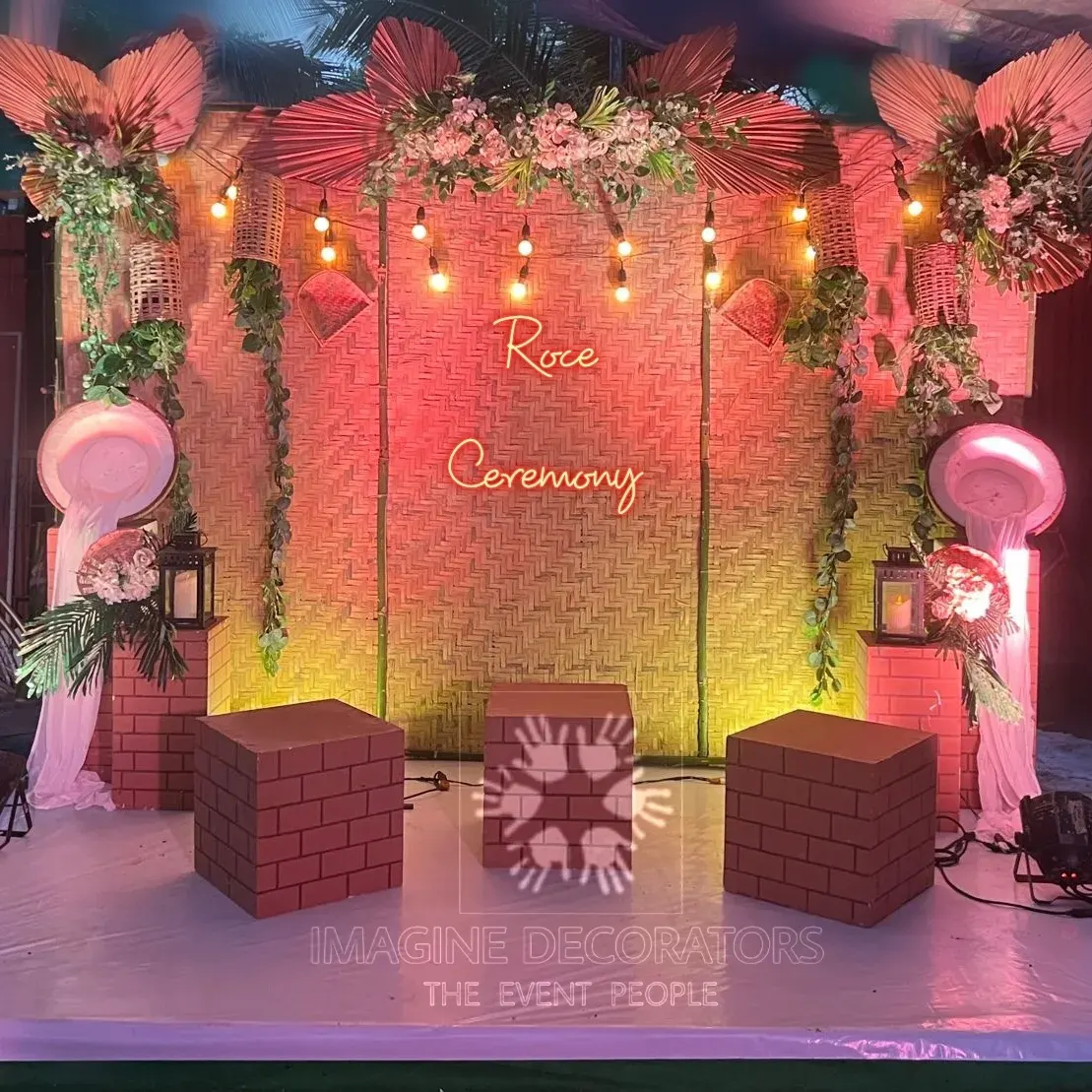 Goan Roce ceremony backdrop with bamboo weave, terracotta and neon signage